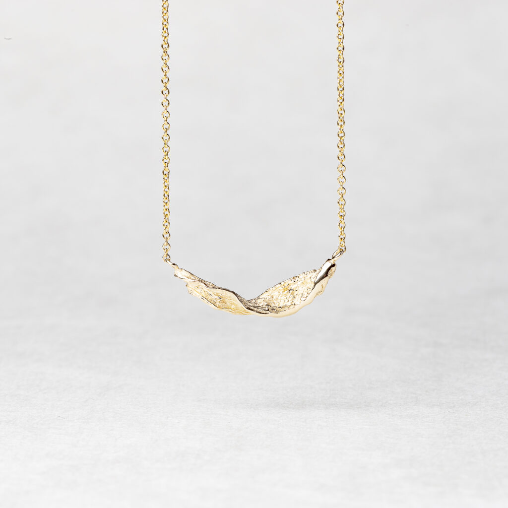 Ocean Wave Necklace in recycled 14k gold, featuring elegant waves and a lustrous finish."