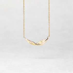 Ocean Wave Necklace in recycled 14k gold, featuring elegant waves and a lustrous finish."