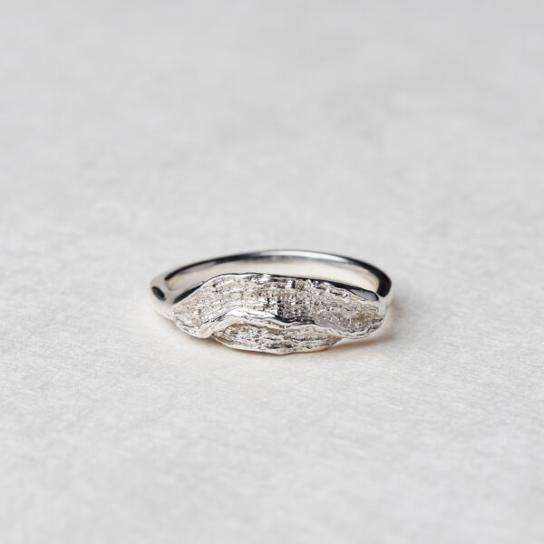 Handmade silver ring with ocean wave-inspired design and organic curves