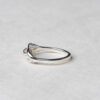 Ethically crafted silver ring with flowing, patterned strand resembling ocean waves"