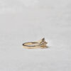 Side view of the Ocean Wave ring, featuring a flowing band of recycled 14k gold with naturally colored diamonds in a gradient reflecting the colors of the sea.