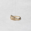 Side view of the Ocean Wave ring, featuring a flowing band of recycled 14k gold with naturally colored diamonds in a gradient reflecting the colors of the sea.